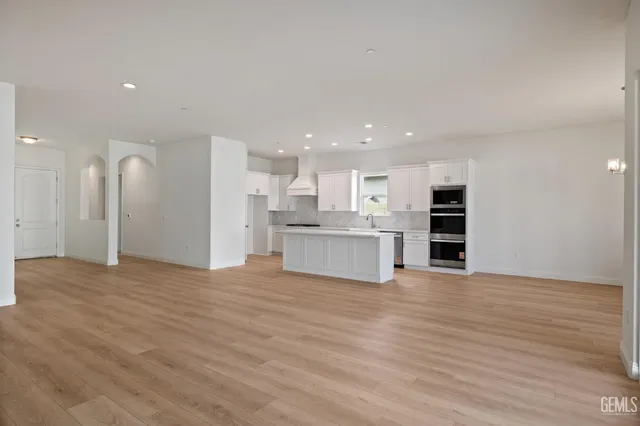 a view of kitchen with wooden floor and windows