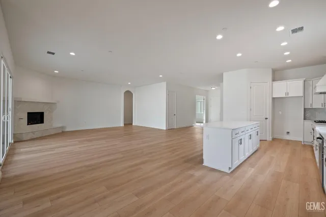 a large kitchen with a sink and a large window