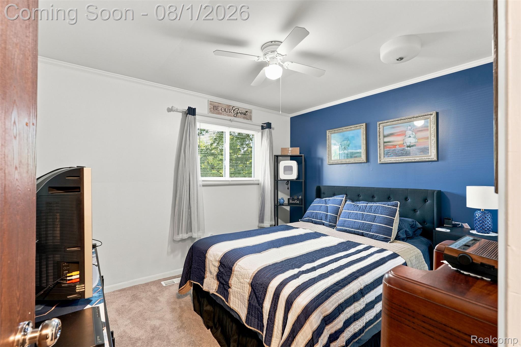 3744 Fish Lake Road Lapeer, MI 48446 - Photo 18 of 50 Bedroom featuring a window with natural light, a ceiling fan, a blue accent wall, and carpeting