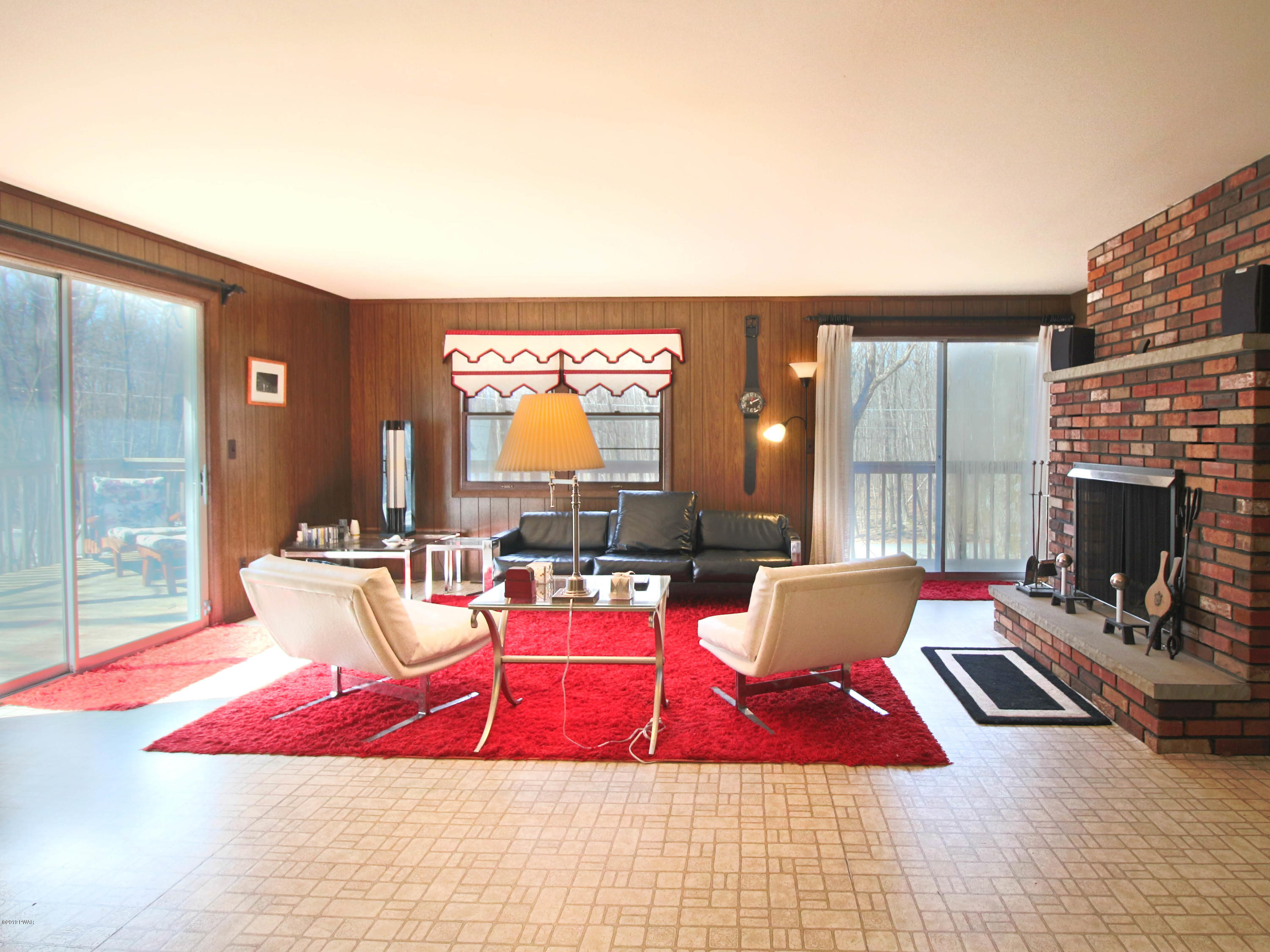 152 Butternut Road Milford, PA 18337 - Photo 6 of 27 a living room with furniture a rug and a fireplace