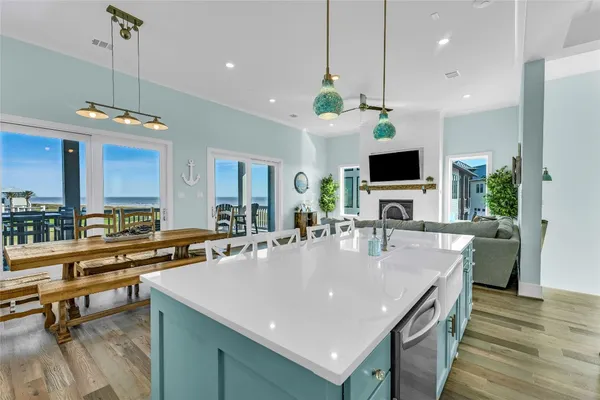 a large kitchen with a table and chairs