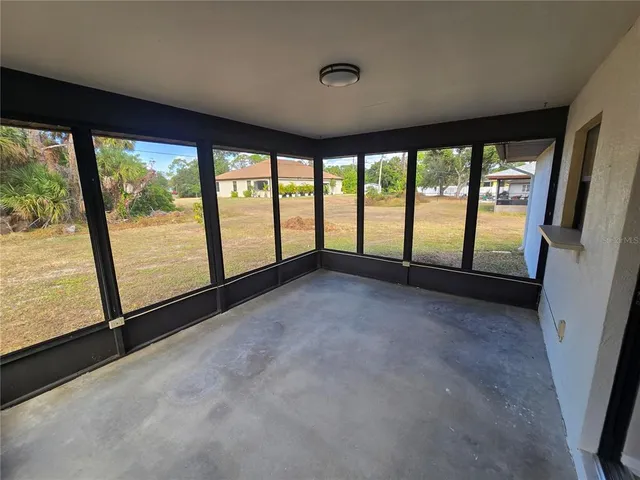 a view of an empty room with large windows