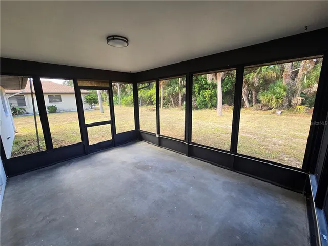 a view of empty room with large windows