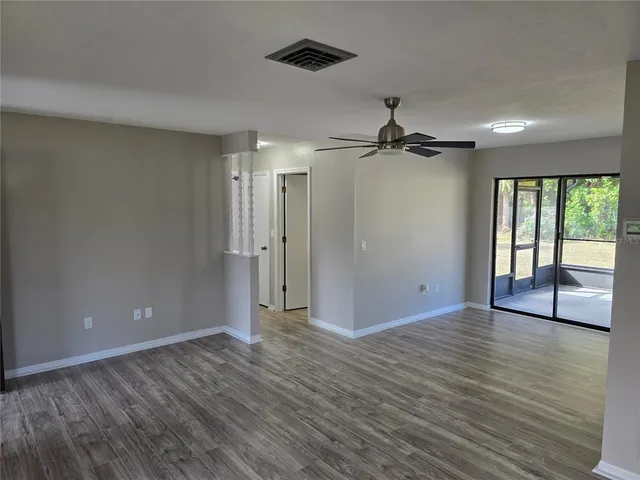 wooden floor in an empty room with a window