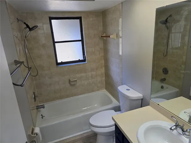 a bathroom with a toilet sink and shower