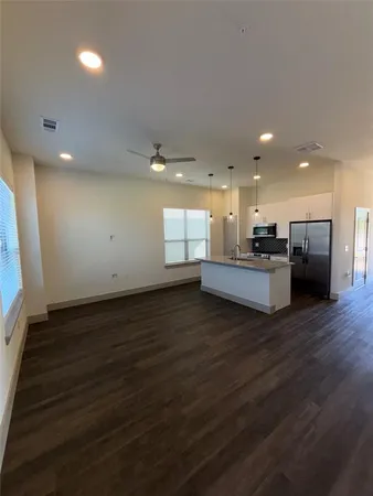 a view of kitchen with cabinets and wooden floor