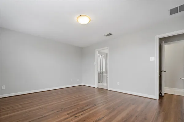 a view of a room with wooden floor