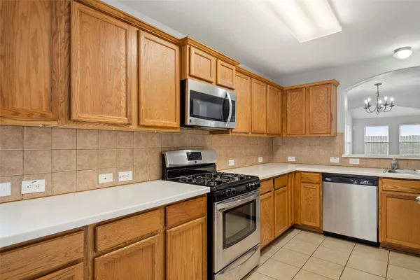 a kitchen with granite countertop cabinets stainless steel appliances a sink and cabinets