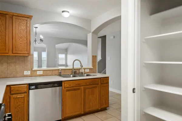 a kitchen with a sink and a mirror