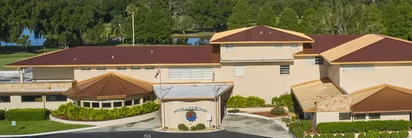 a aerial view of a house with a yard and balcony