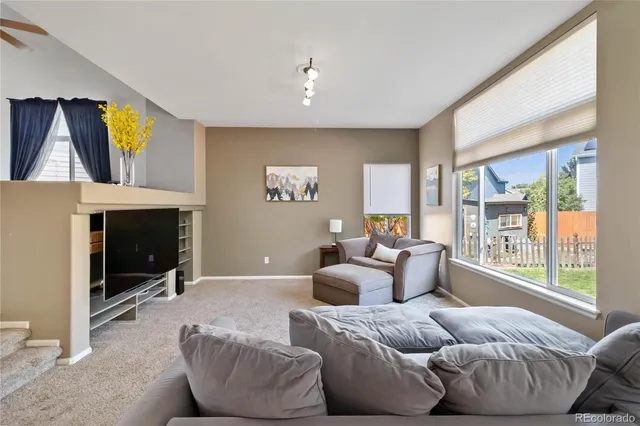 a living room with furniture a window and a fireplace
