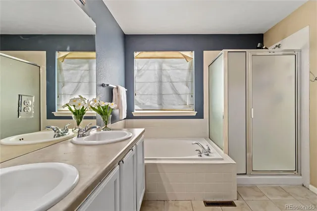 a bathroom with a granite countertop sink and a bathtub