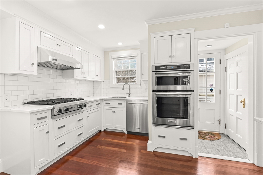 89 Lovell Road Melrose, MA 02176 - Photo 15 of 38 a kitchen with stainless steel appliances granite countertop a stove a sink and a refrigerator