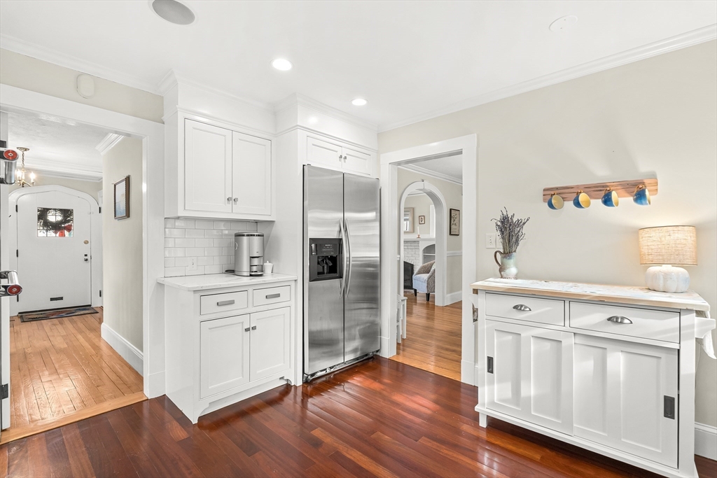 89 Lovell Road Melrose, MA 02176 - Photo 17 of 38 a kitchen with white cabinets and stainless steel appliances