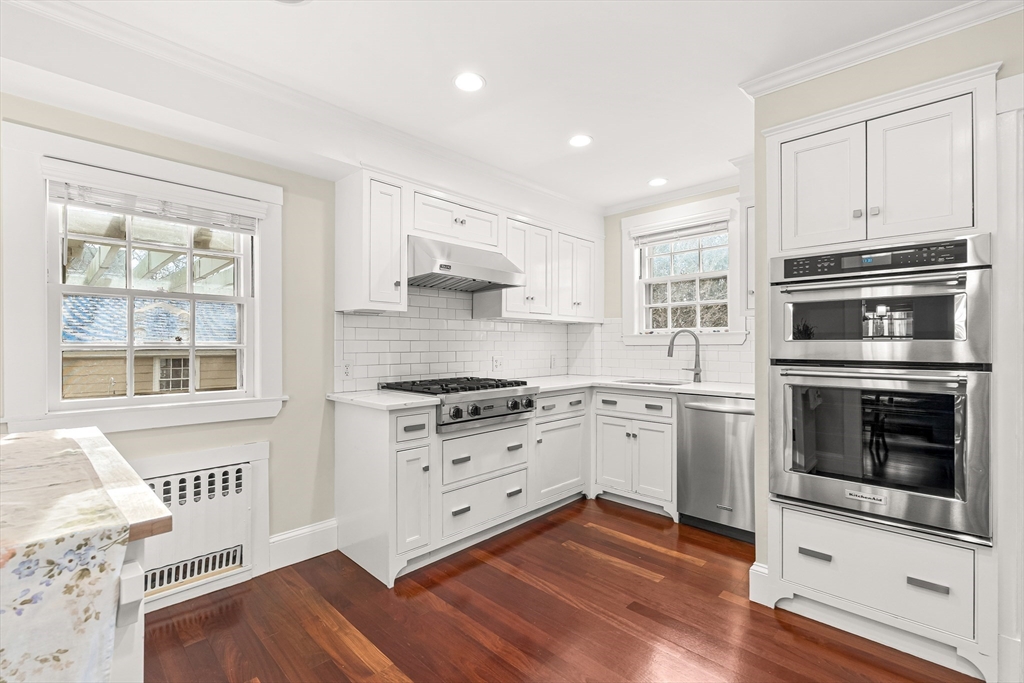 89 Lovell Road Melrose, MA 02176 - Photo 18 of 38 a kitchen with granite countertop a stove a sink and a refrigerator