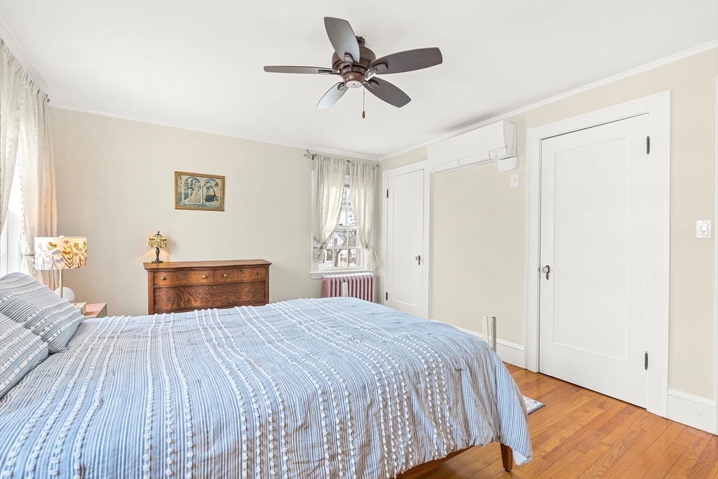 89 Lovell Road Melrose, MA 02176 - Photo 24 of 38 a bedroom with a bed and a chandelier