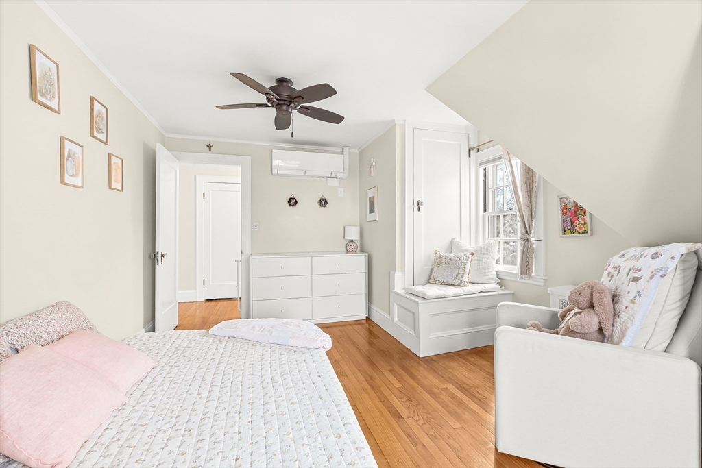 89 Lovell Road Melrose, MA 02176 - Photo 26 of 38 a bedroom with a bed and a chandelier