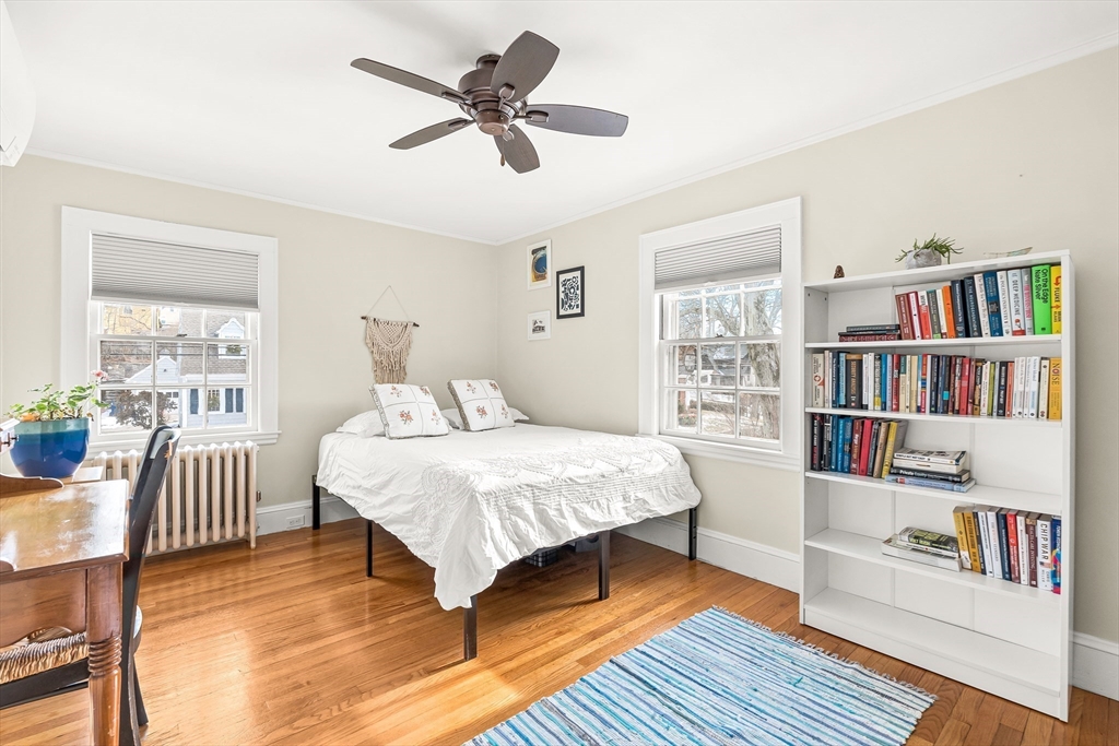 89 Lovell Road Melrose, MA 02176 - Photo 27 of 38 a bedroom with a bed a dresser and a book shelf