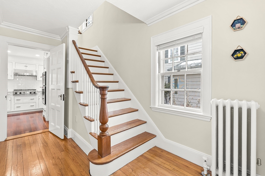 89 Lovell Road Melrose, MA 02176 - Photo 5 of 38 a view of a hallway with windows and stairs