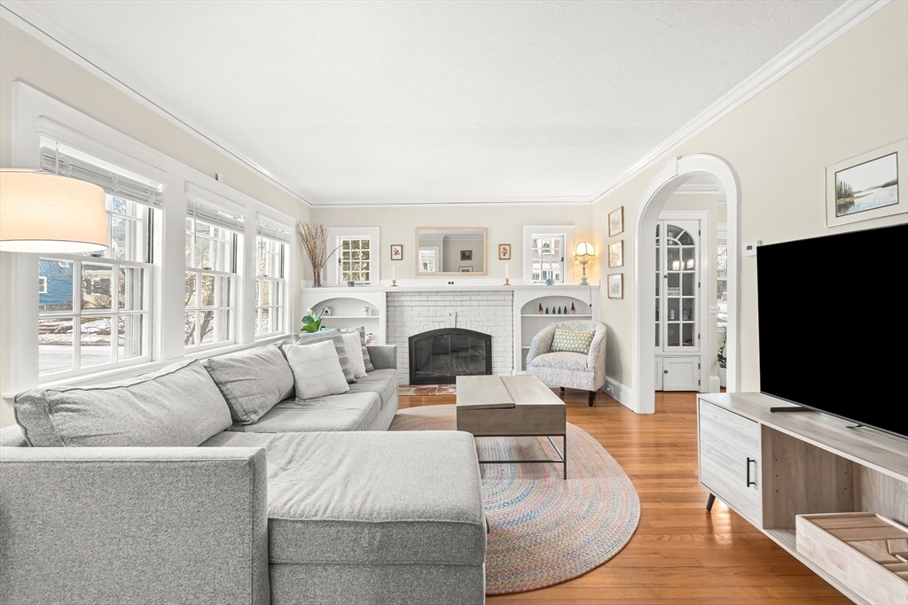 89 Lovell Road Melrose, MA 02176 - Photo 7 of 38 a living room with fireplace furniture and a flat screen tv