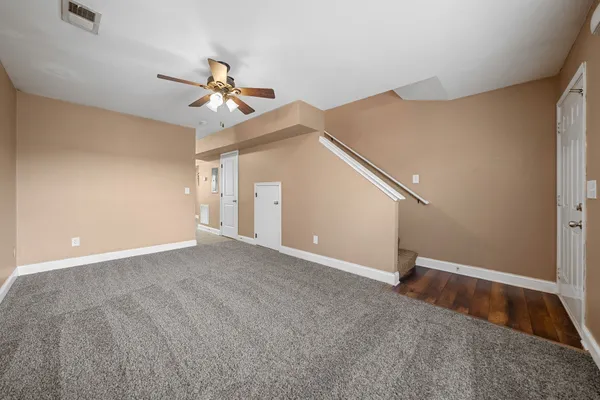 a view of an empty room with a ceiling fan