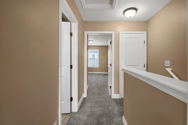 a view of hallway with bathroom