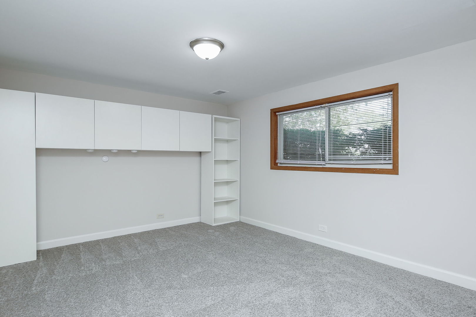 458 White Pine Road Buffalo Grove, IL 60089 - Photo 17 of 25 a view of an empty room with a cabinet and wooden floor