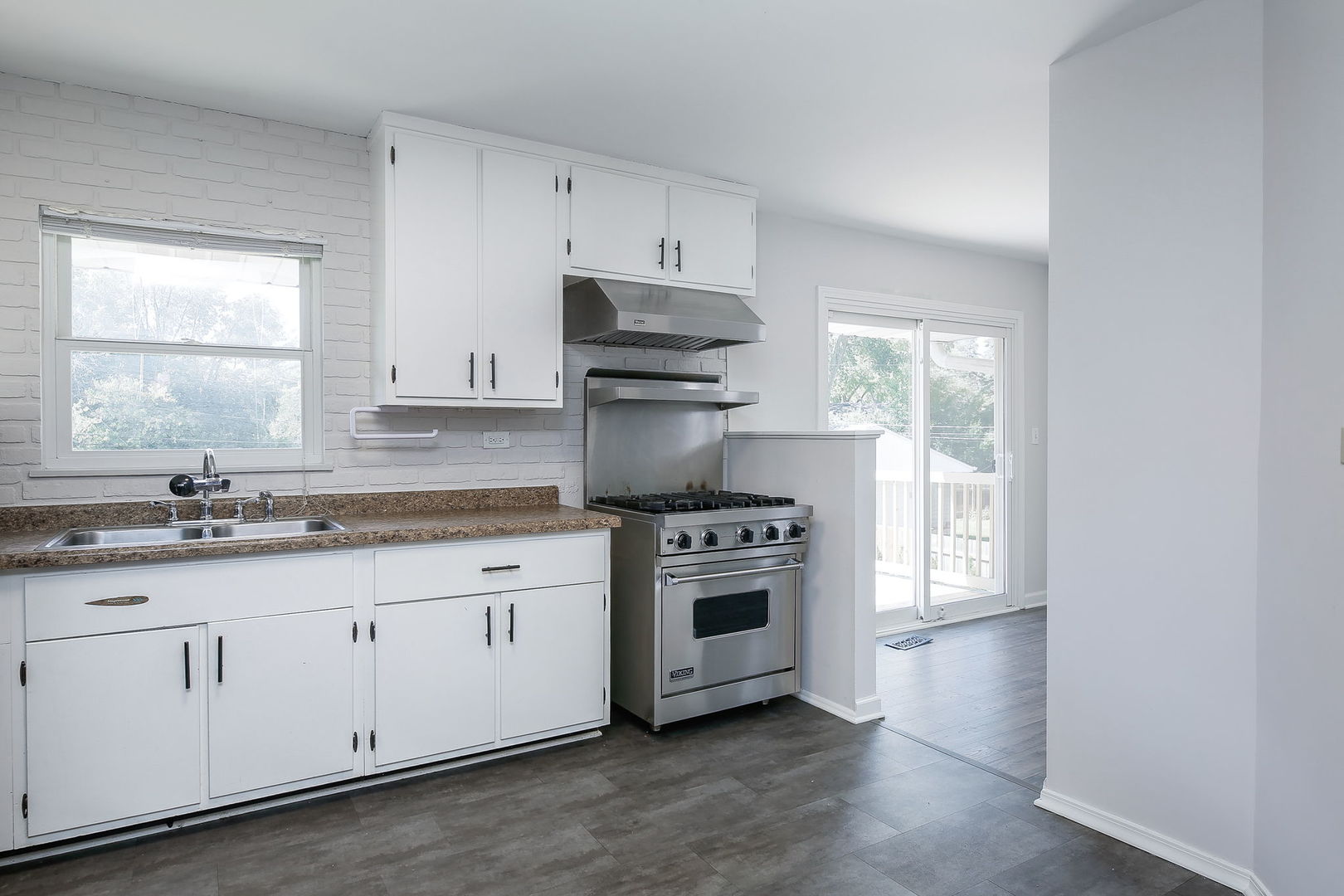 458 White Pine Road Buffalo Grove, IL 60089 - Photo 7 of 25 a kitchen with granite countertop white cabinets and stainless steel appliances