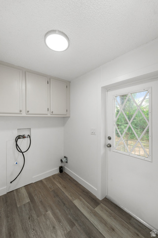 2875 North 400 West, Unit 7 Layton, UT 84041 - Photo 6 of 29 Dedicated utility space featuring wood-finish flooring, white cabinetry, and a bright overhead light fixture