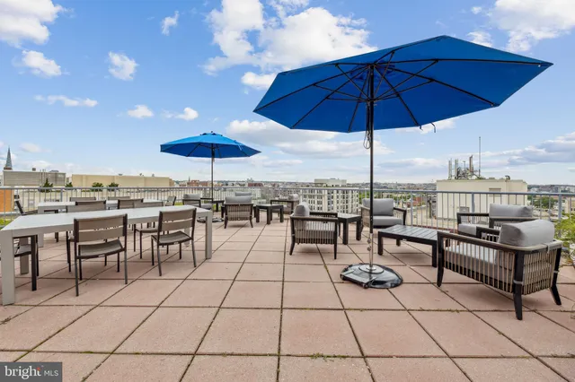 a view of a terrace with furniture and umbrella