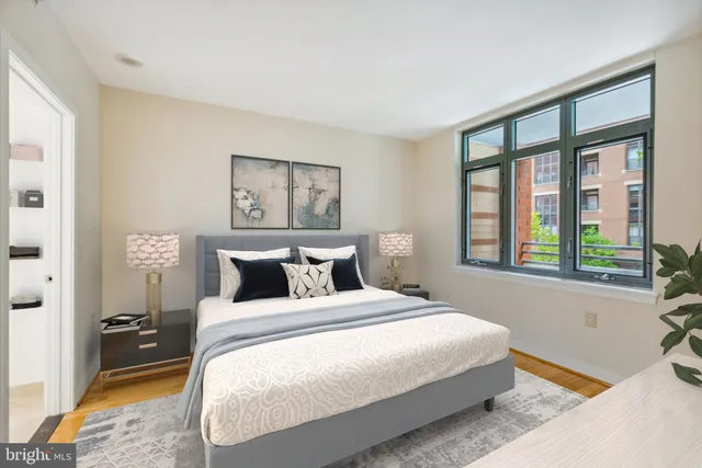 a bedroom with a large bed and a window