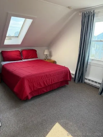 a bed sitting in a room next to a window