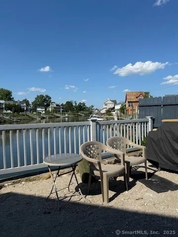 a view of a roof deck with furniture