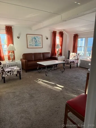 a living room with furniture and a lamp