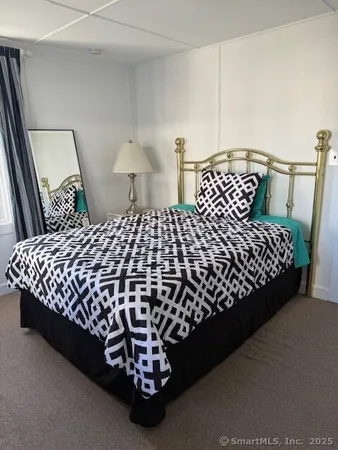 a bed sitting in a bedroom next to a window