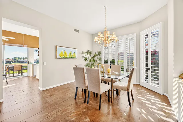a view of a hallway with wooden floor and entryway
