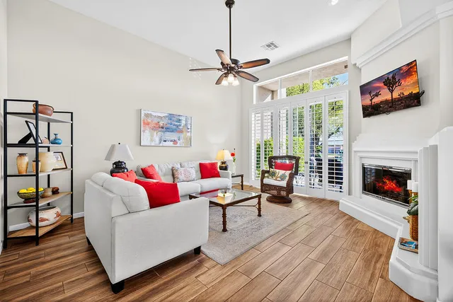 a living room with furniture and a potted plant