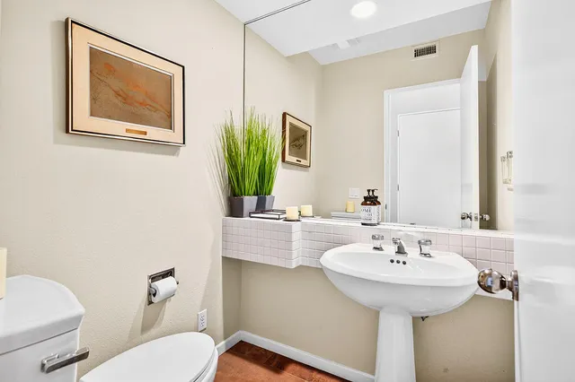 a spacious bathroom with a double vanity sink a mirror and a shower