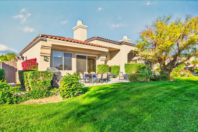 a front view of house with yard and outdoor seating