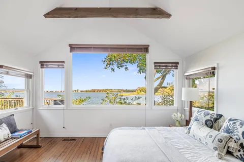 a bedroom with a bed and window