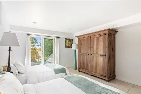 a bedroom with 2 bed and a window