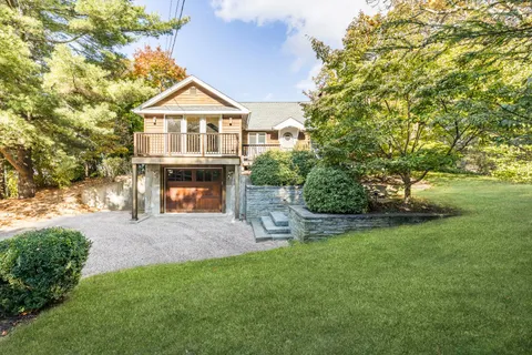 a front view of a house with a garden and yard