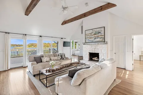 a living room with furniture large window and a fireplace
