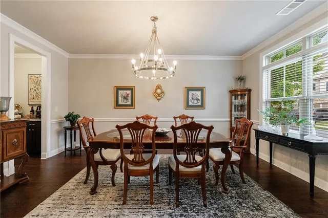 a view of a dining room with furniture window and wooden floor