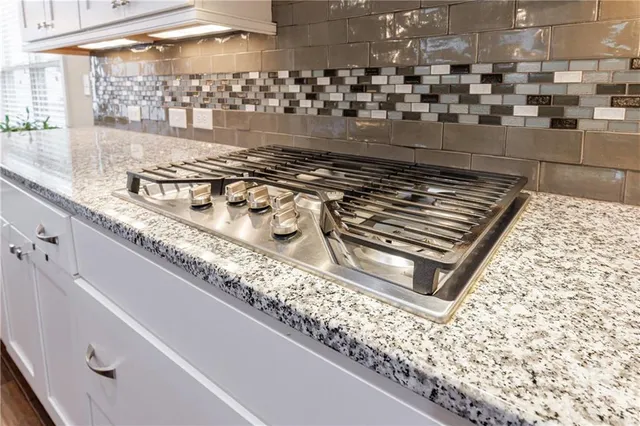 a bathroom with a double vanity sink mirror and bathtub