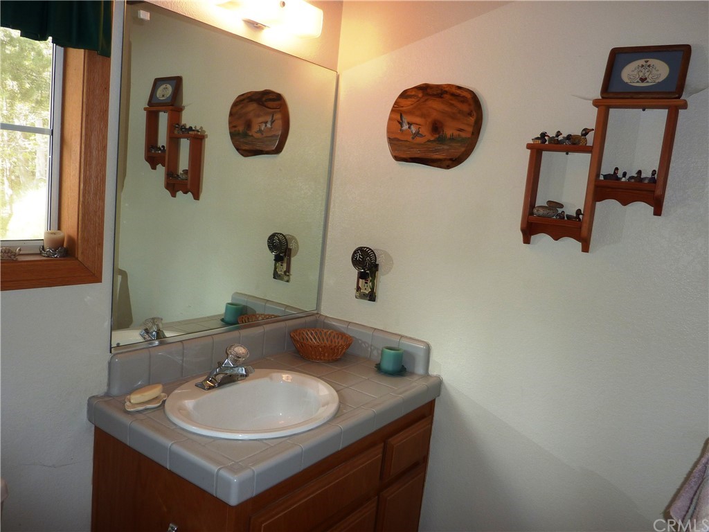 25274 N Road Twin Peaks, CA 92391 - Photo 16 of 35 a bathroom with a sink and a mirror
