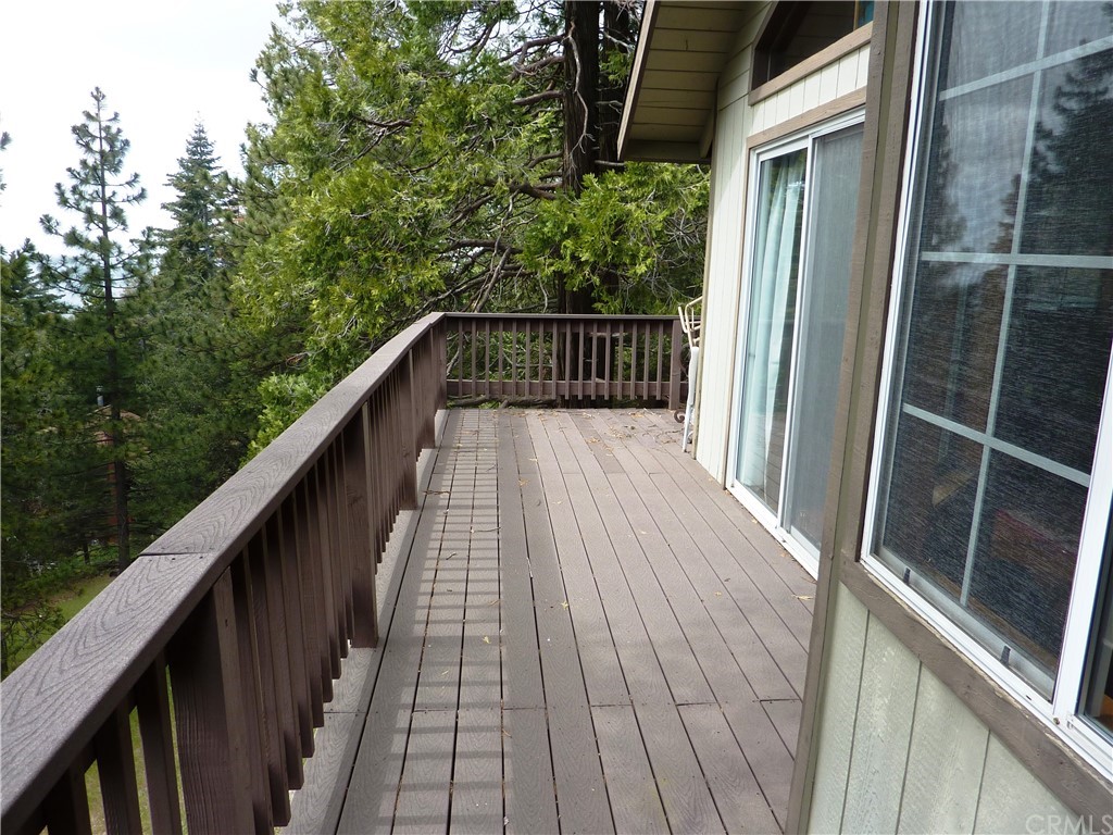 25274 N Road Twin Peaks, CA 92391 - Photo 18 of 35 a balcony with wooden floor in front of a house