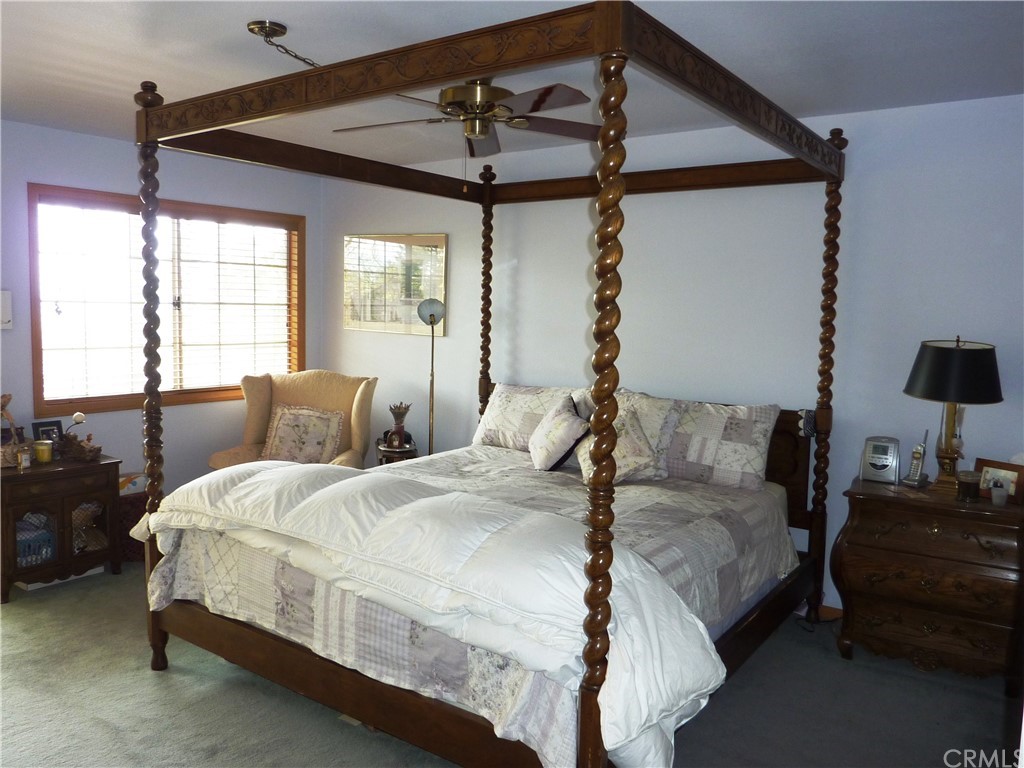 25274 N Road Twin Peaks, CA 92391 - Photo 19 of 35 a large bedroom with bed window and lamp