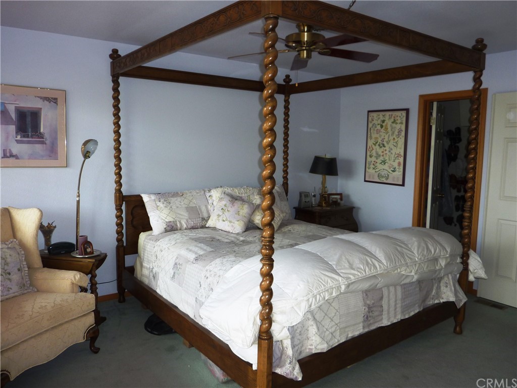 25274 N Road Twin Peaks, CA 92391 - Photo 20 of 35 a bedroom with a bed and a chandelier