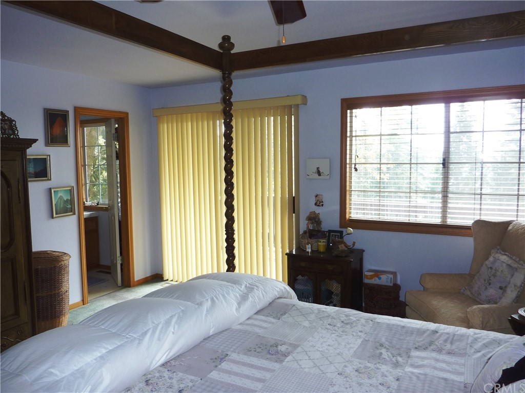 25274 N Road Twin Peaks, CA 92391 - Photo 21 of 35 a bedroom with a bed and a large window
